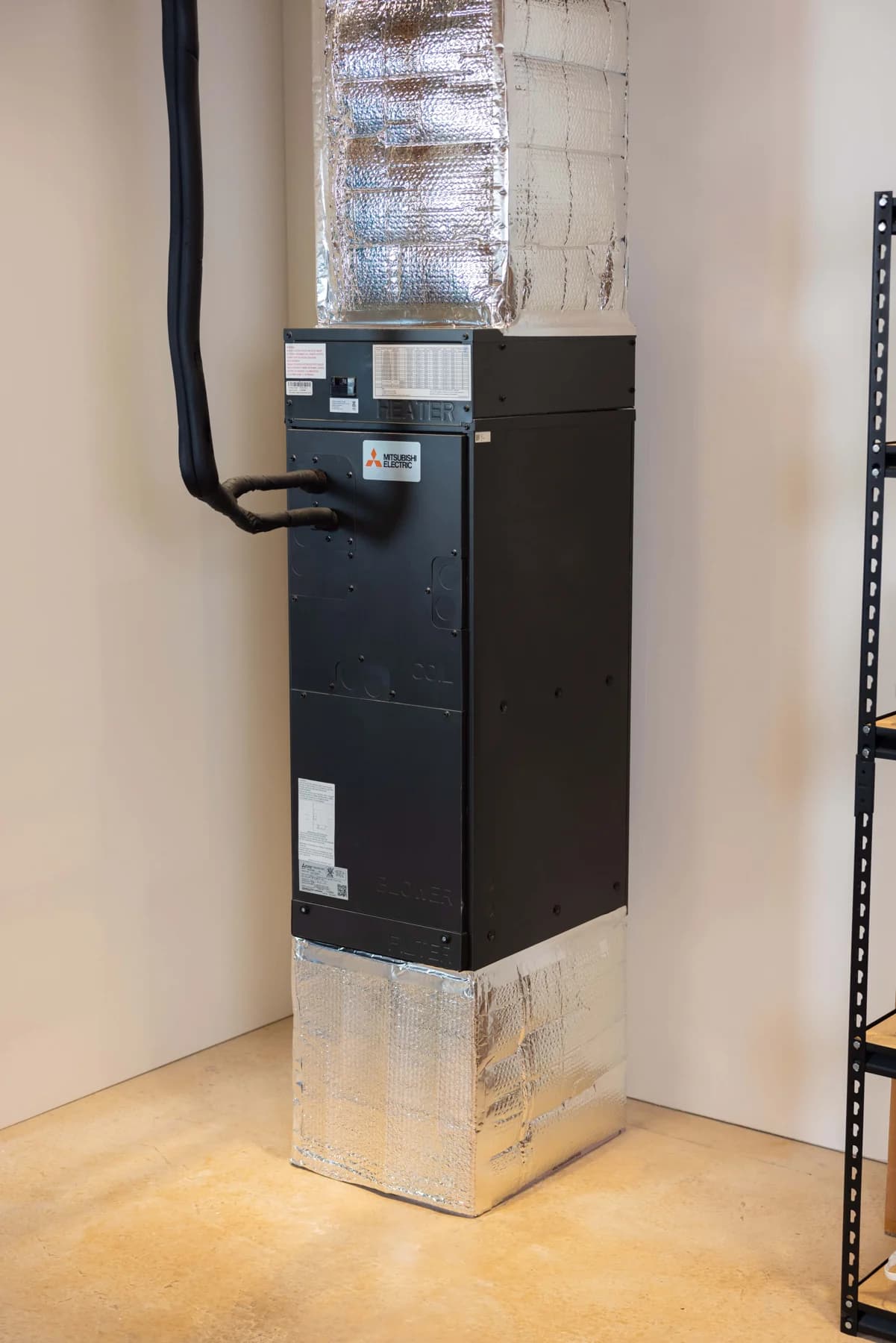Indoor air handler with duct transitions and refrigerant lines